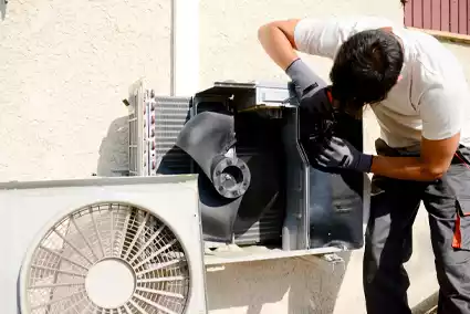 Technician installing an air conditioning unit